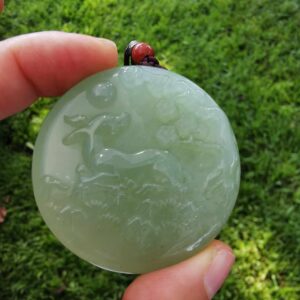 Fingers holding Jade Bambi Pendant