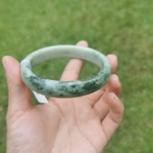 a hand holding Green Jade Bangle