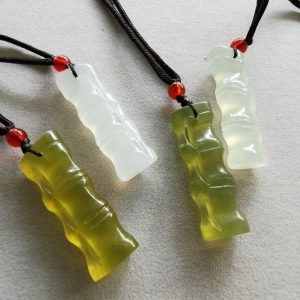 four jade items in the shape of Bamboo